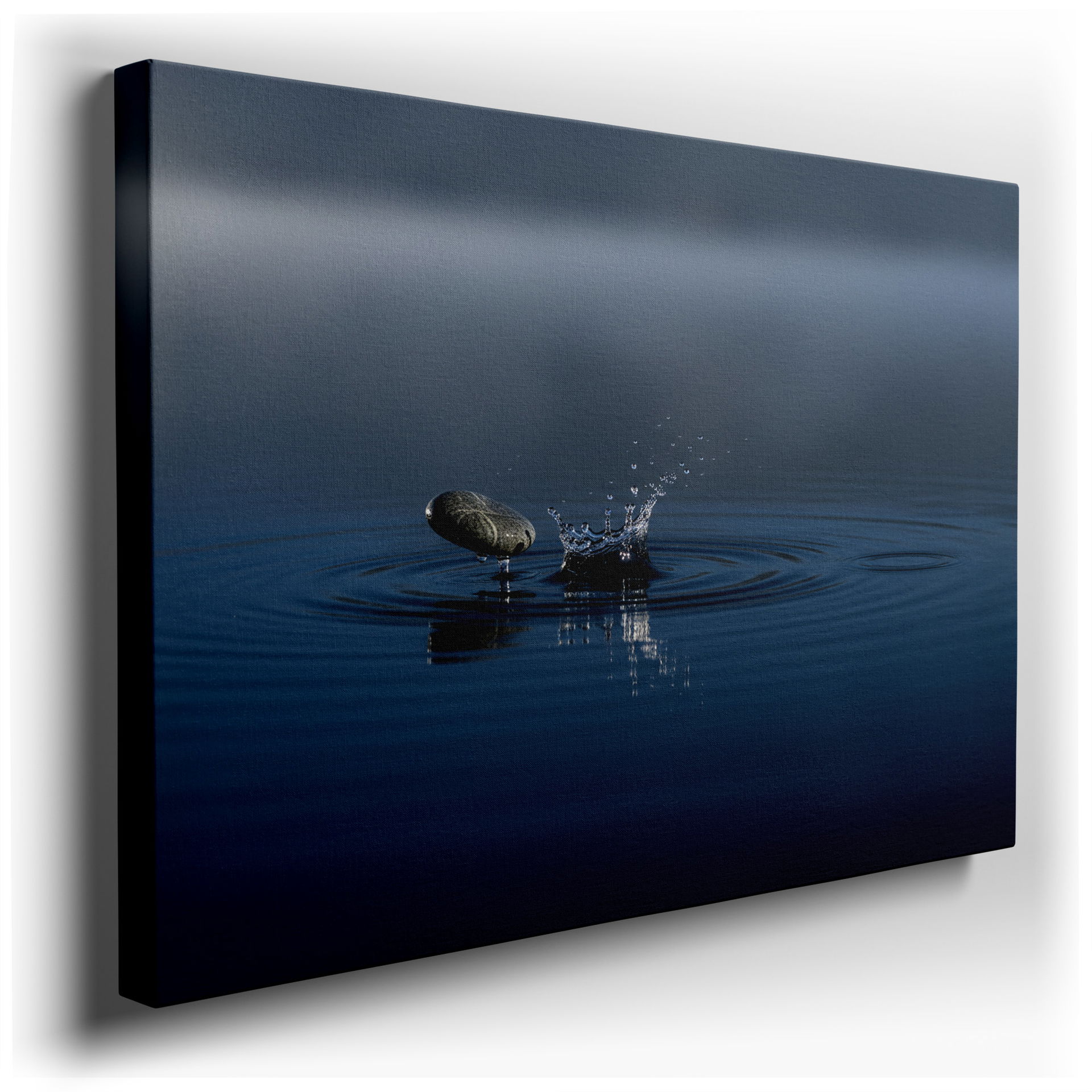 A serene stone creates a splash in calm water, ripples forming in this captivating wall art.