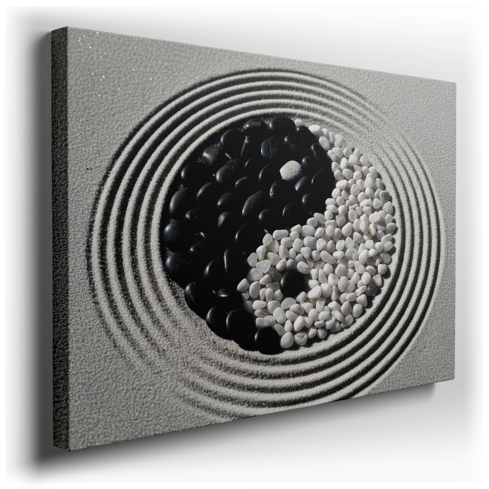 Balanced Yin Yang stone wall art on sand background, offering a peaceful aesthetic for home decor.