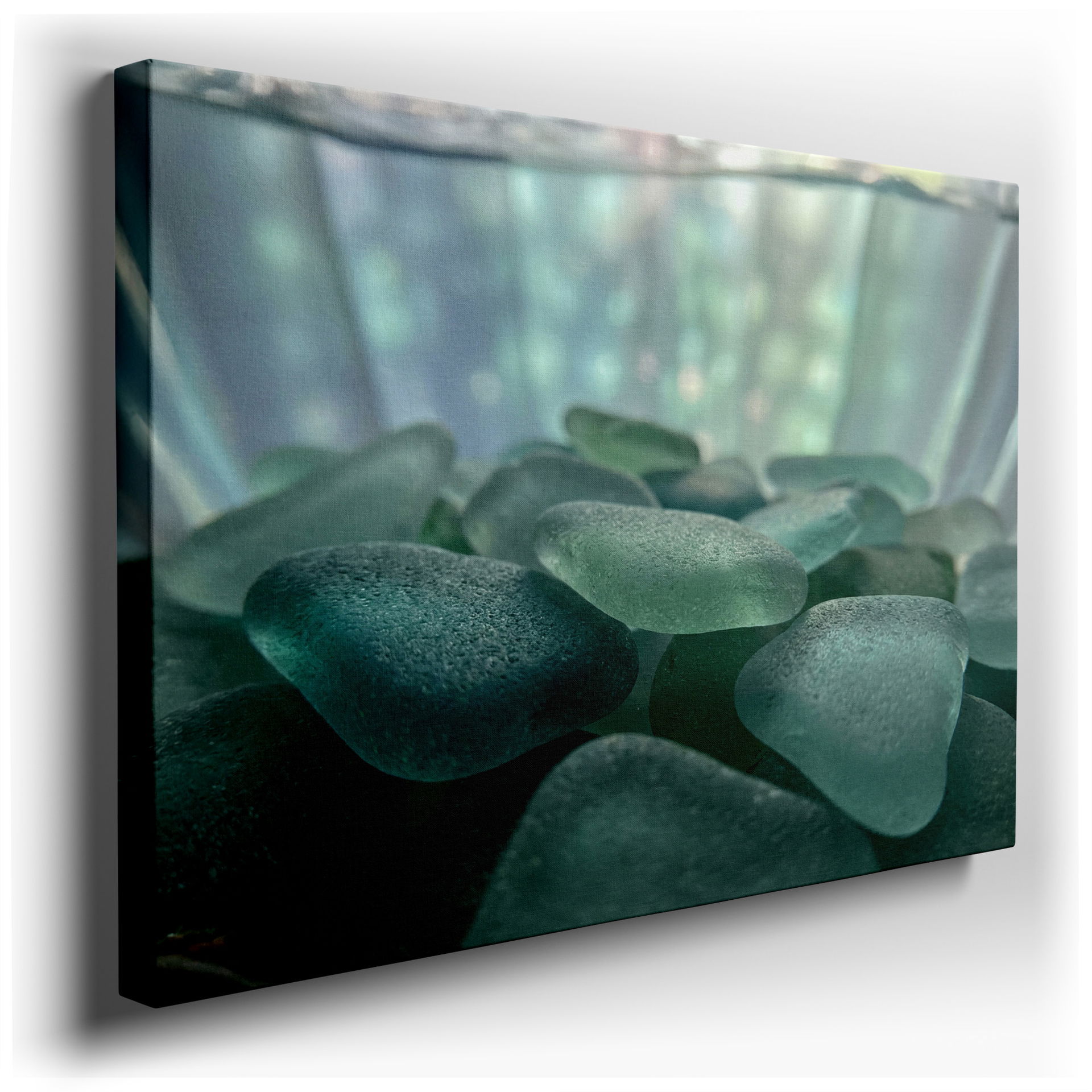 Close-up wall art featuring smooth sea glass pieces in serene blues, creating calming texture.
