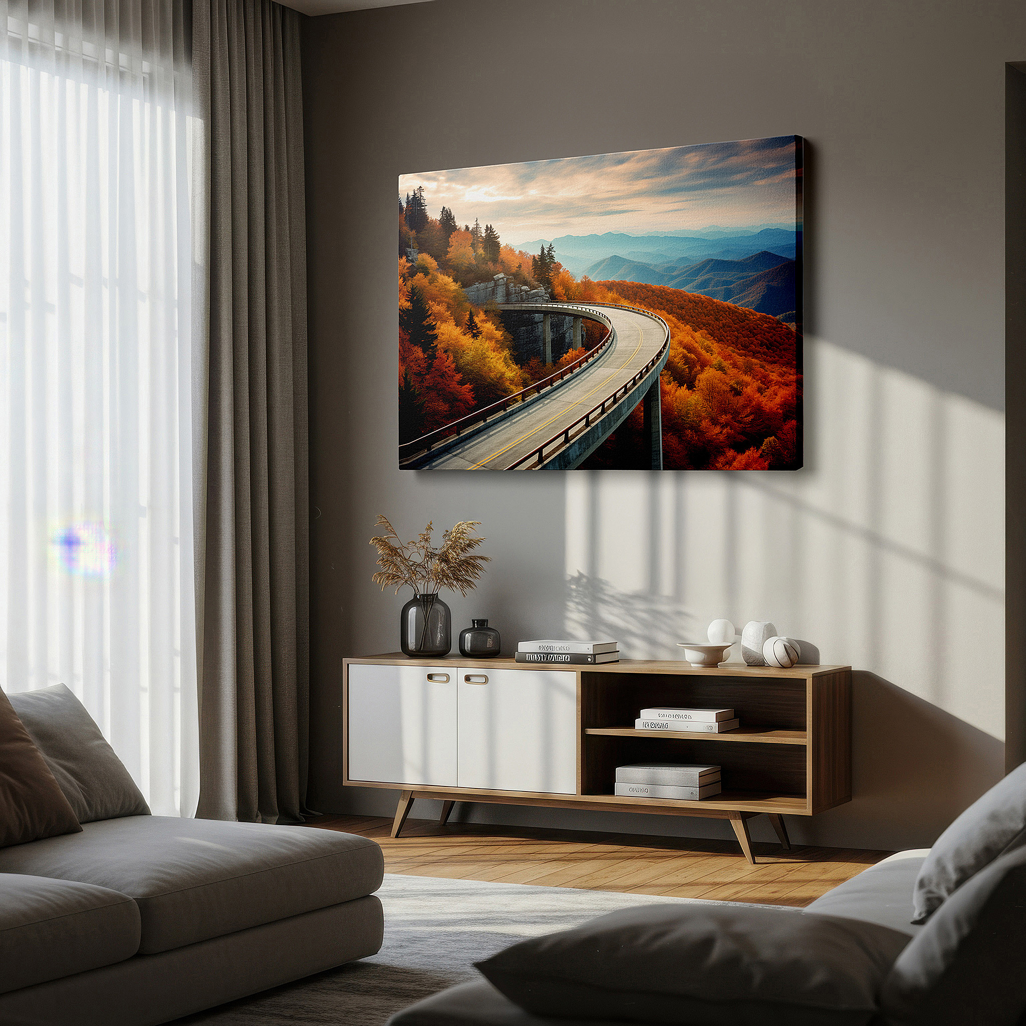 Displayed above a contemporary leather sofa in warm light — autumn majesty journey - winding road with fiery foliage and steep mountains large wall art, canvas wall art, wall decor for office