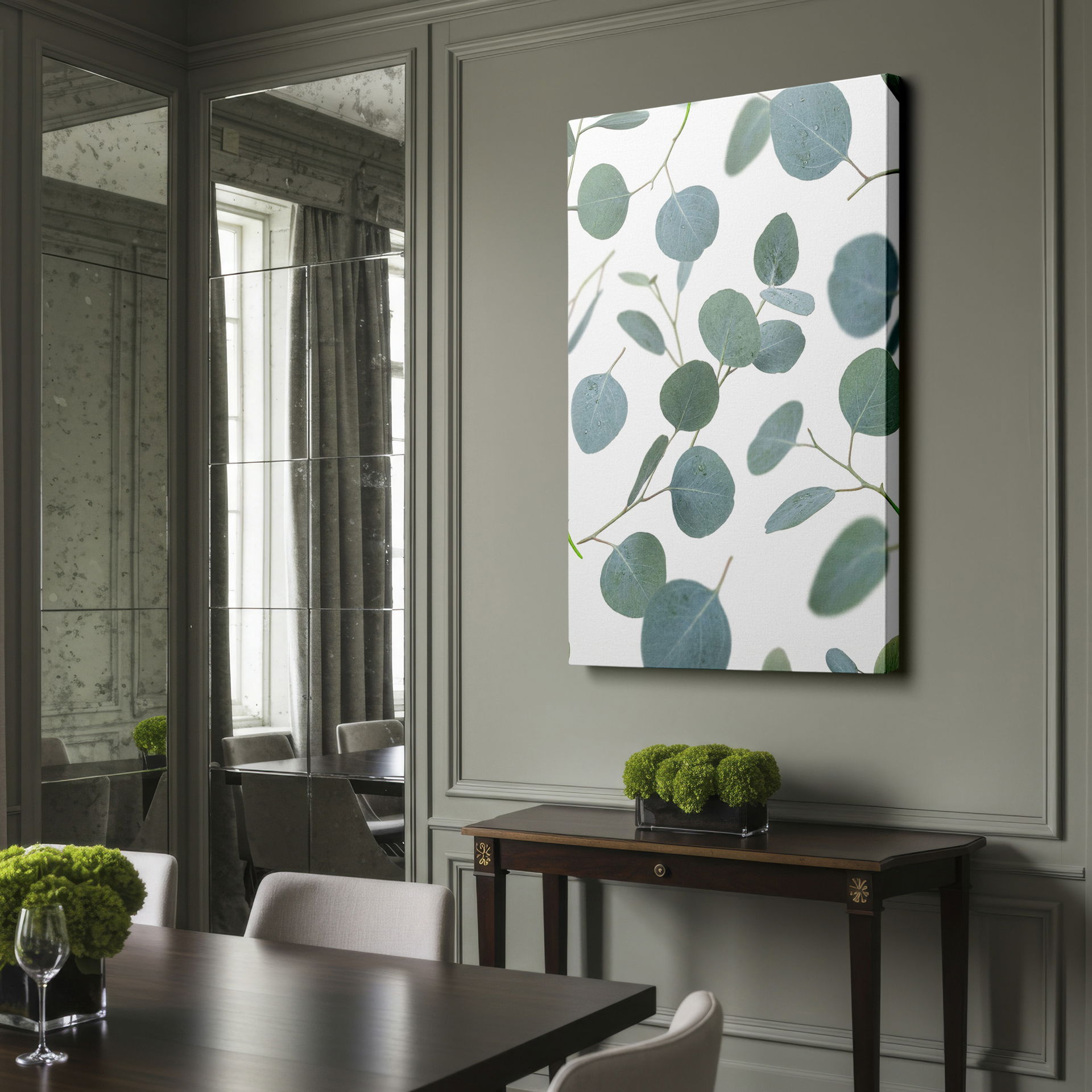 Delicate silver-green eucalyptus leaves on wall art float across a clean white surface, a tranquil botanical motif.