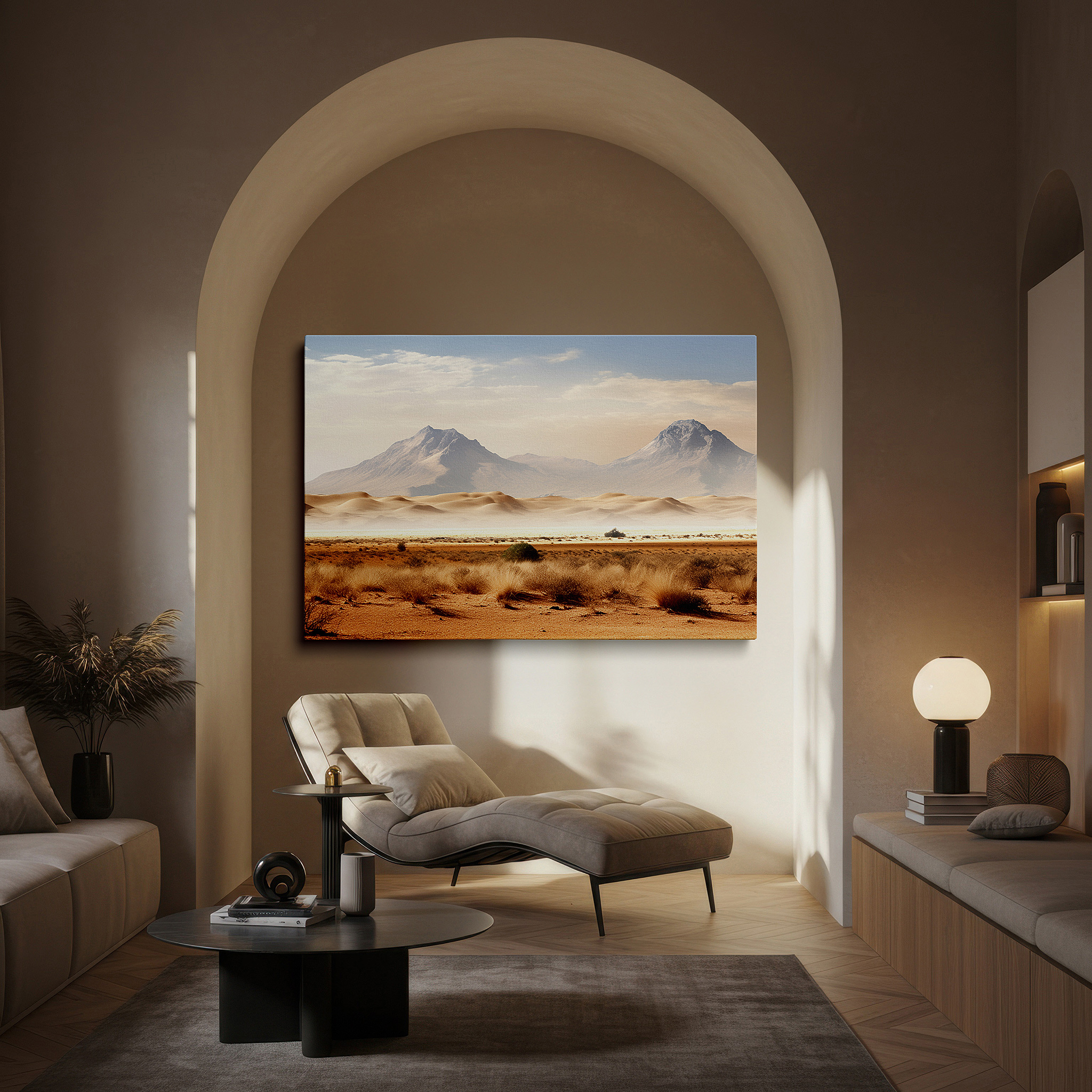 Displayed above a contemporary leather sofa in warm light — earth tone desert dunes and mountain ranges, serene and stark nature canvas, large wall art for office decor