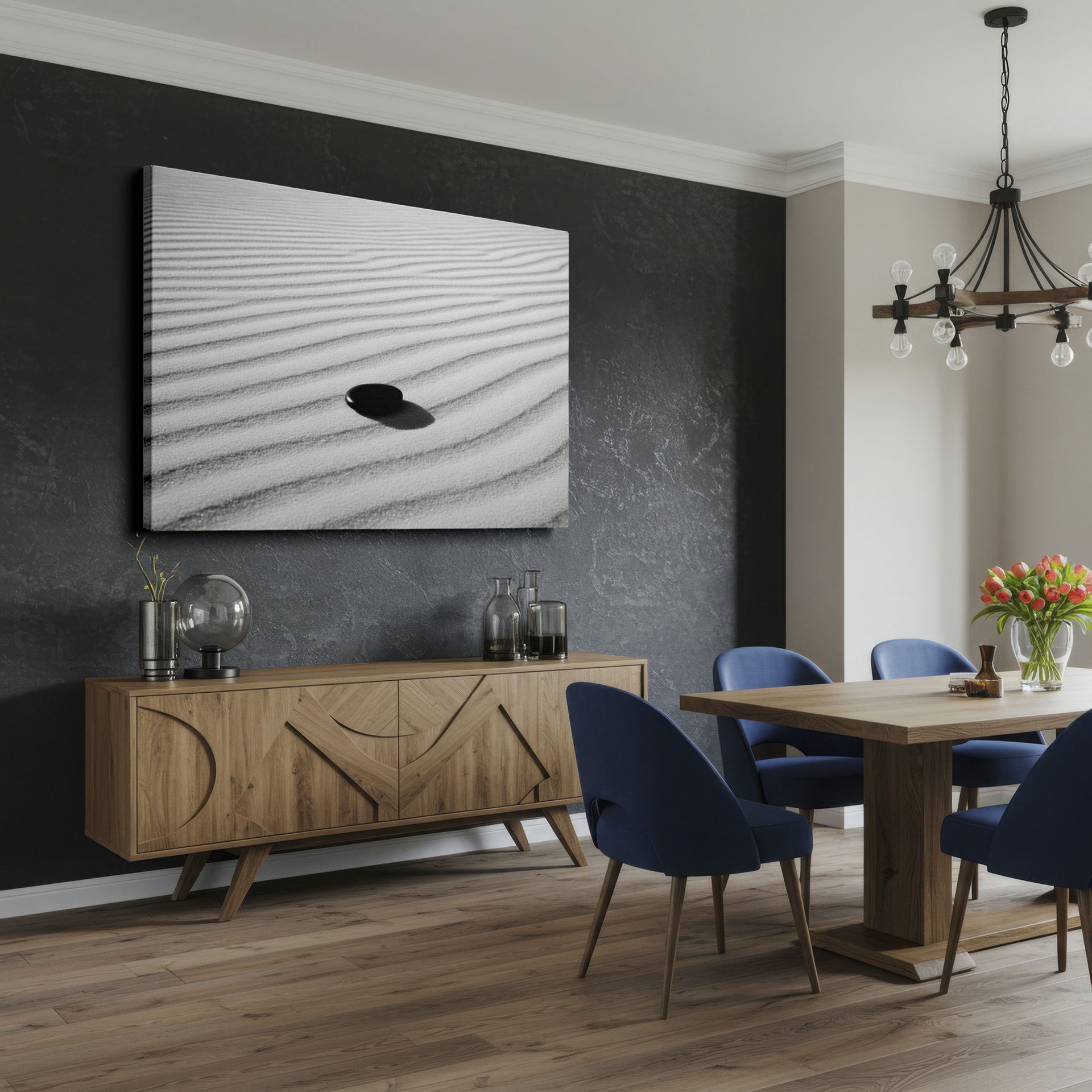 Dark, smooth stone rests on white sand, creating rhythmic patterns in this minimalist wall decor.