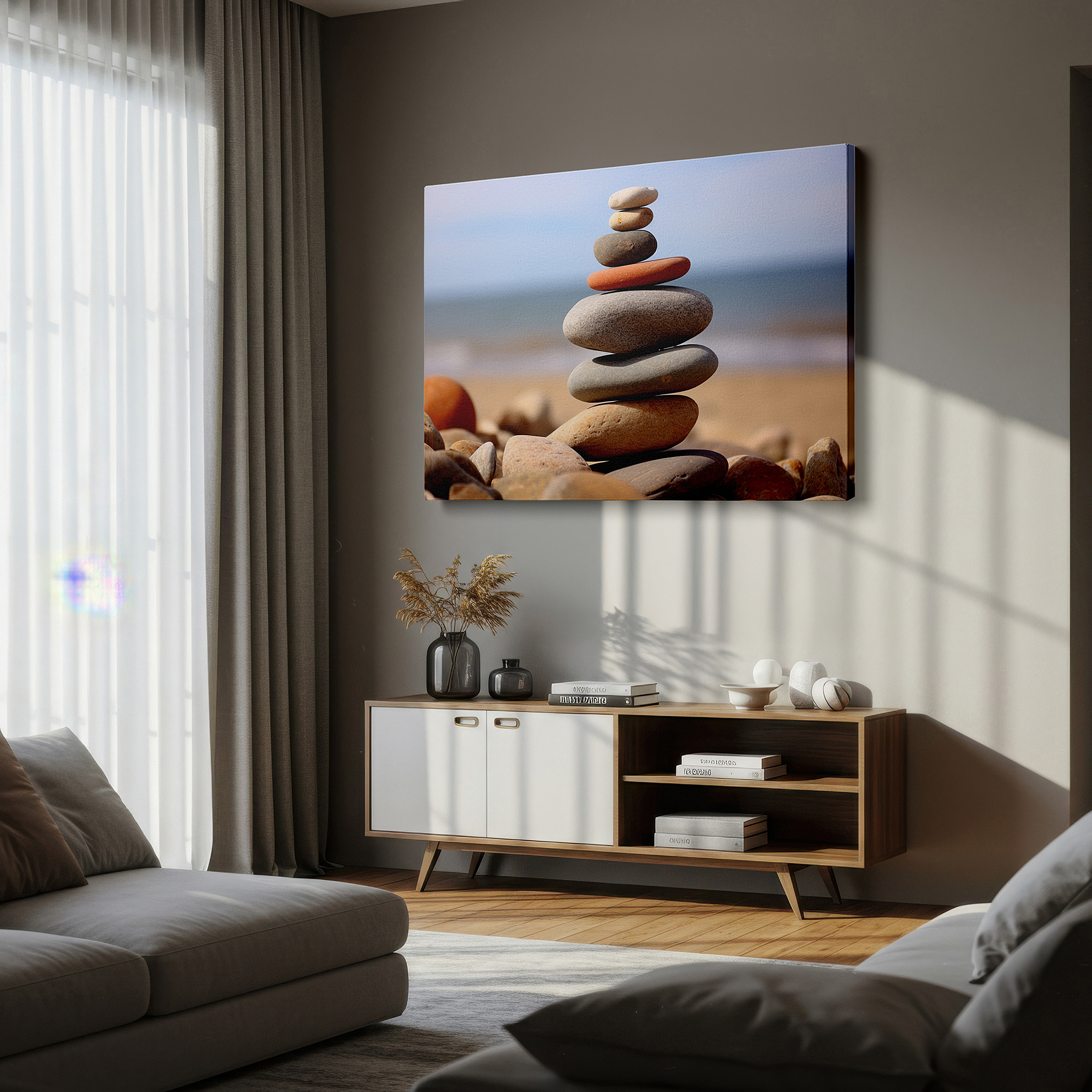Hung in a cozy reading nook beside a floor lamp and bookshelf — wall art: "serenity in balance" - pebbles on a tranquil beach for calm and reflection. large canvas wall art for office and bedroom decor.