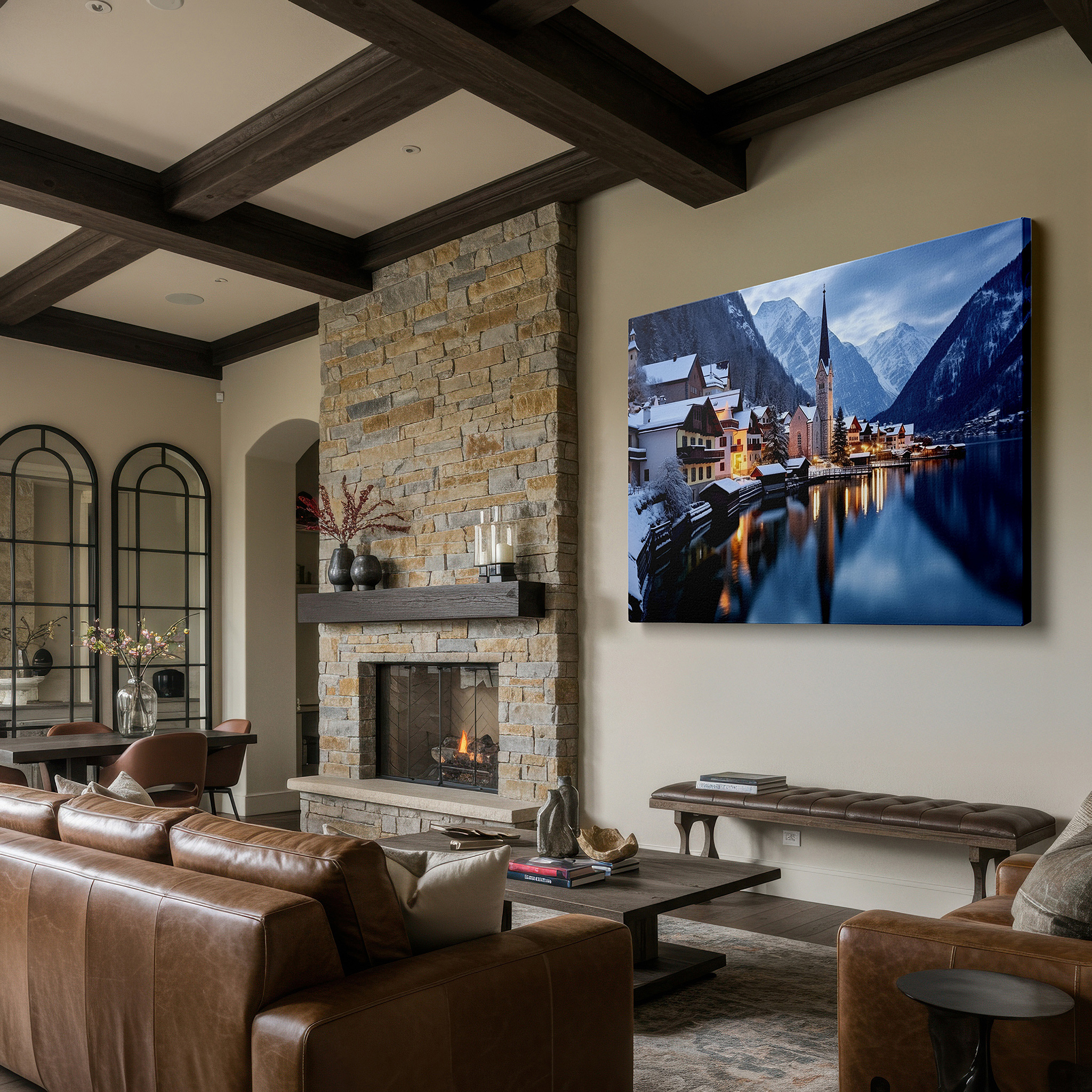 Displayed above a contemporary leather sofa in warm light — serene winter night in a snow-covered village with twinkling lights and majestic mountain reflections large wall art, canvas wall art, wall decor
