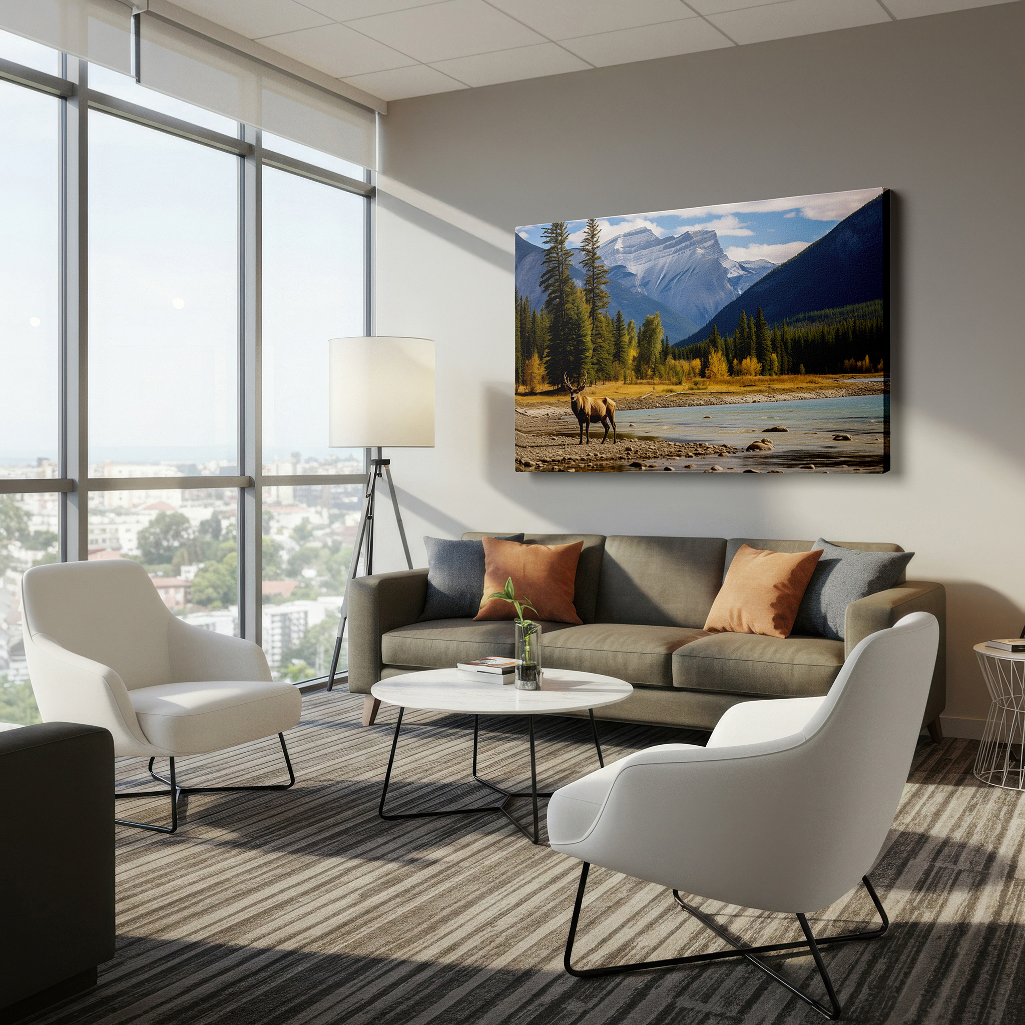 Set in a minimalist interior with textured walls and soft rugs — majestic elk by the serene river with lush scenery and striking mountains - large canvas wall art for office decor